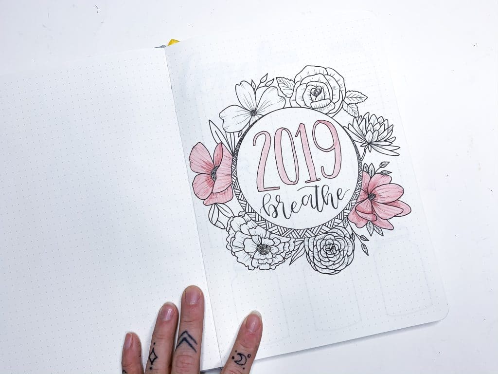 Pink handlettered word breather with floral wreath around it