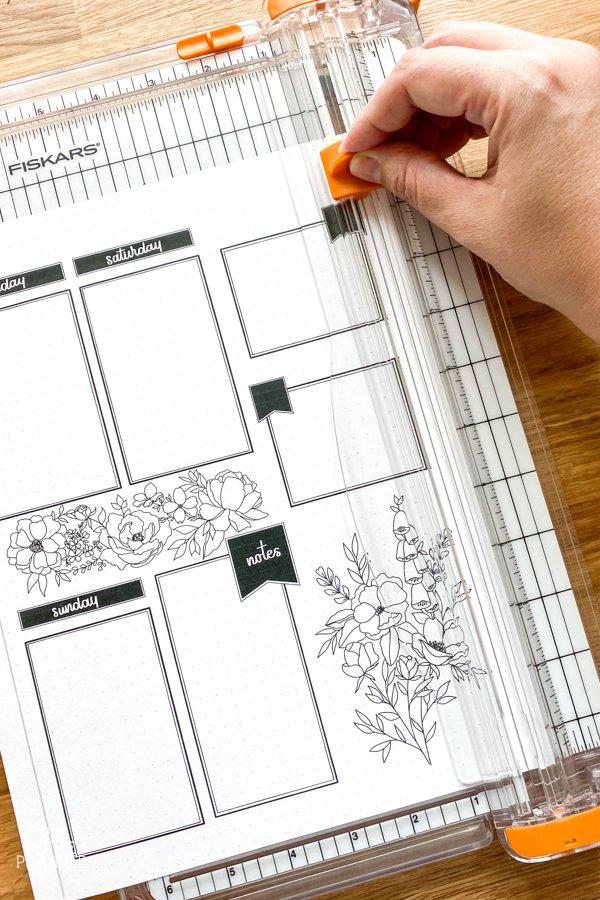 Using paper cutter to trim weekly planner printable to fit journal