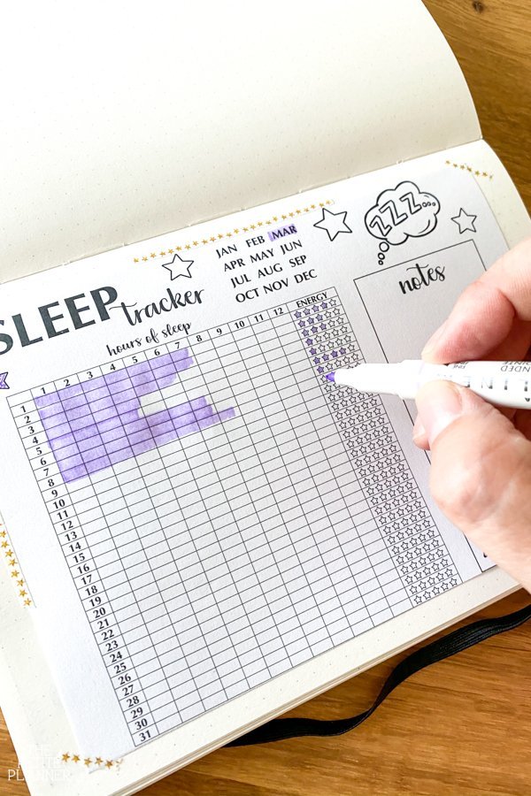 Bullet Journal Sleep Tracker printable taped into a journal