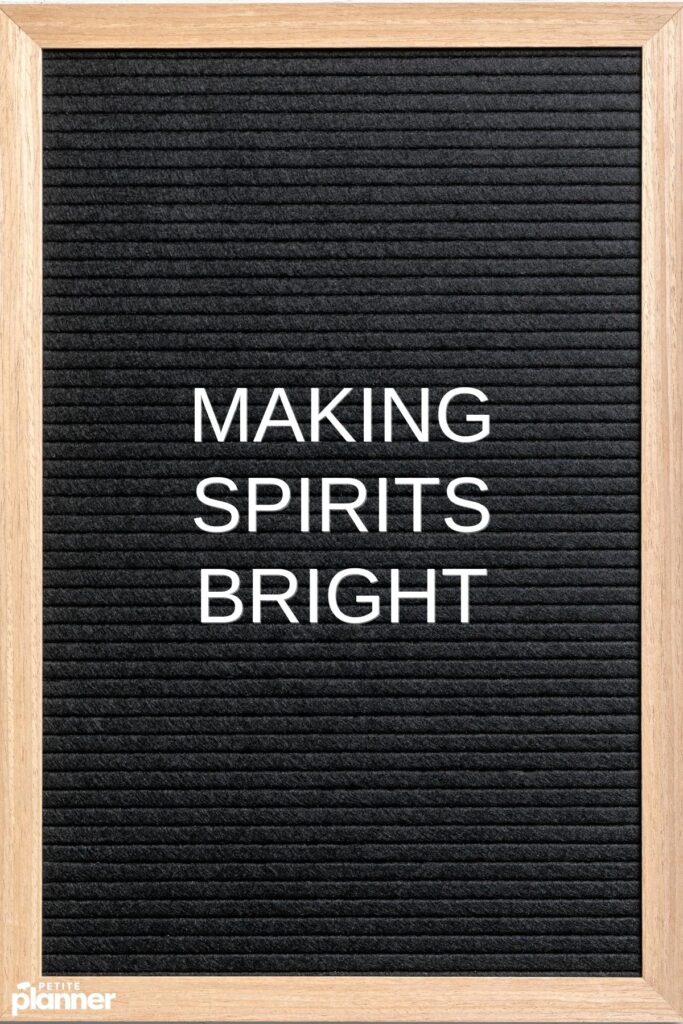 Black letterboard with wood frame with saying "Making Spirits Bright"